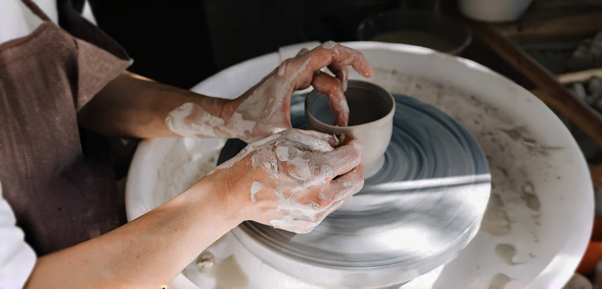 Hands crafting a porcelain bowl on a pottery wheel, showcasing Sino Porcelain-Bowls craftsmanship.