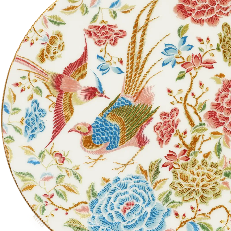Close-up of gold rim and floral bird pattern on Chinoiserie bone china plate.