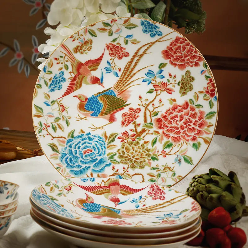 Close-up of floral and bird pattern on stacked Chinoiserie bone china dinner plates.