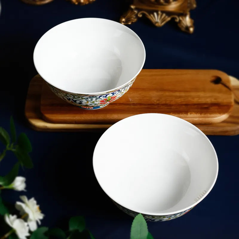 Staggered footed bowls: one on wood tray, one on blue cloth.