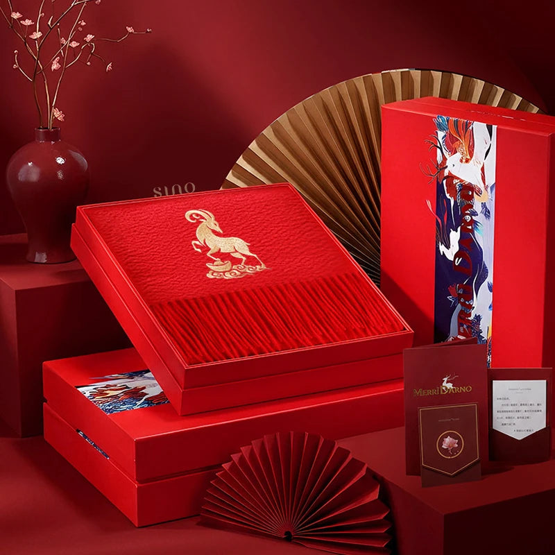 2027 Year of the Goat 100% cashmere scarf with gold goat embroidery, presented in an elegant red gift box for Chinese New Year gifting.