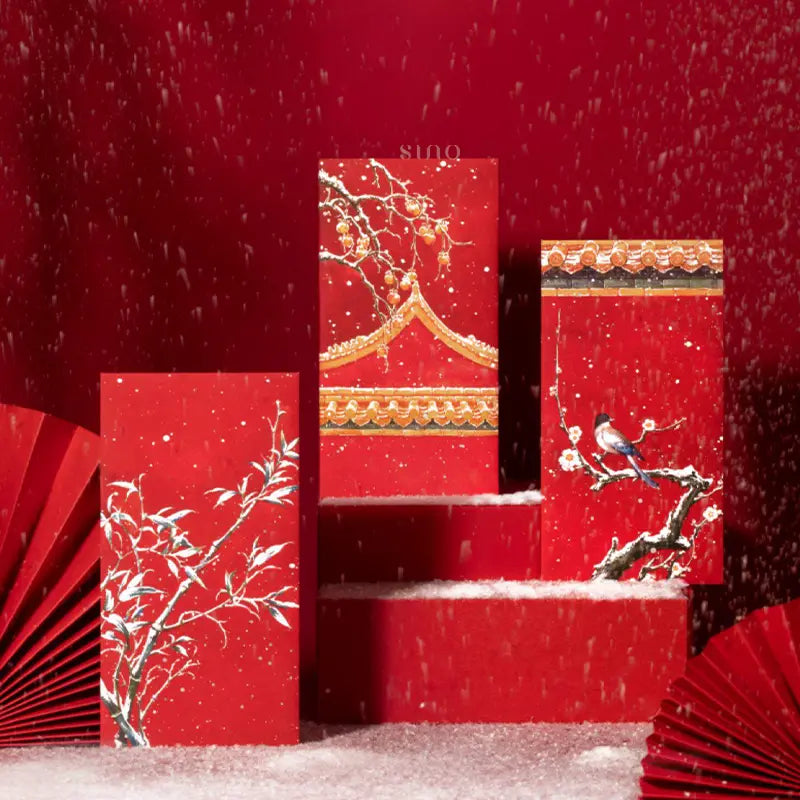 Three traditional Chinese New Year red envelopes featuring snowy bamboo, plum blossoms, a colorful bird, and Chinese palace roof details.