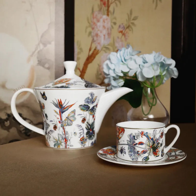 Coffee set arrangement with floral vase decoration.