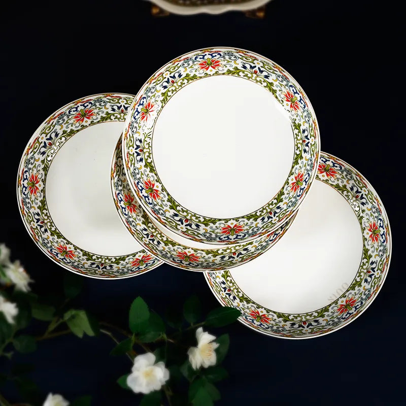 Stacked Chinoiserie bone china plates with tea accessories on blue cloth.