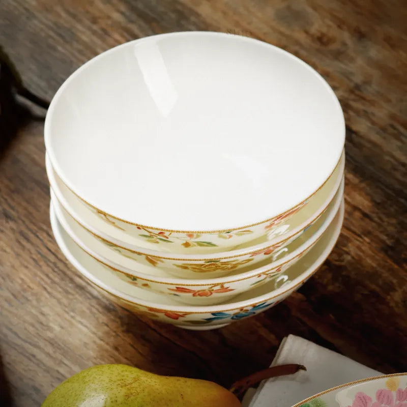 Angled view of four stacked Chinoiserie footed bowls showing translucency.
