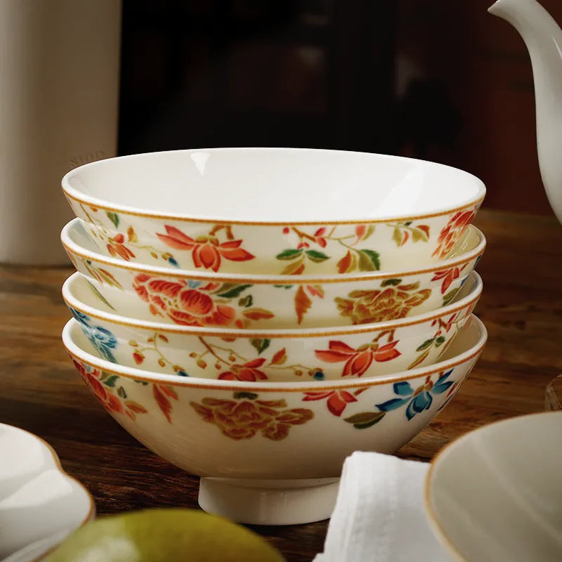 Four Chinoiserie footed bowls stacked on table, front view.