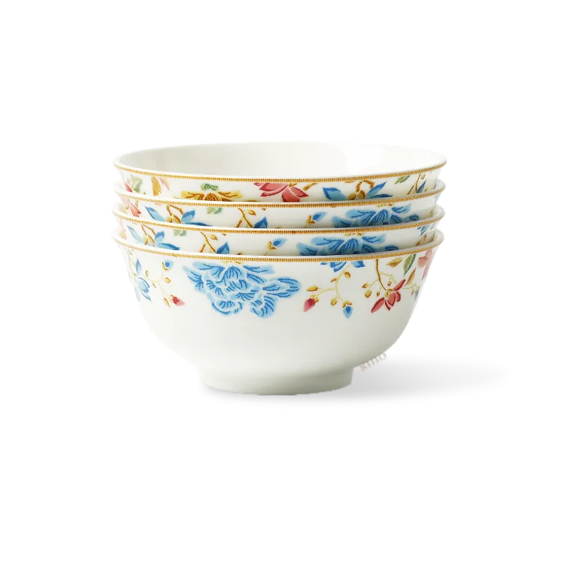Four stacked floral chinoiserie bone china round bowls on white background.