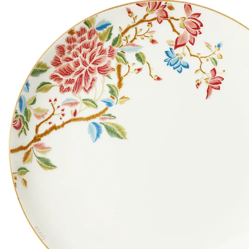 Close-up of floral rim pattern and fine craftsmanship on Chinoiserie bone china plate.