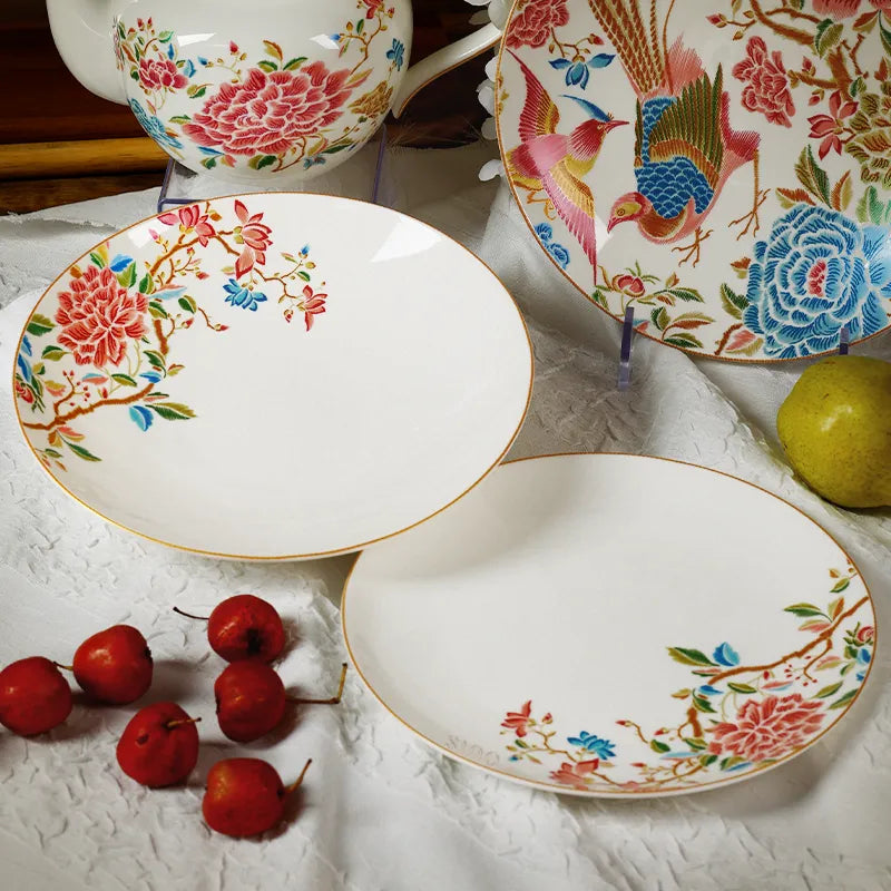 Two overlapping Chinoiserie salad plates showing inner surface texture with fruits.