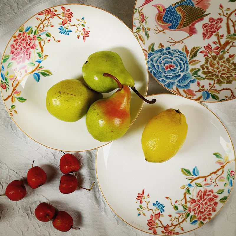 Two overlapping Chinoiserie salad plates with fruits on top plate.