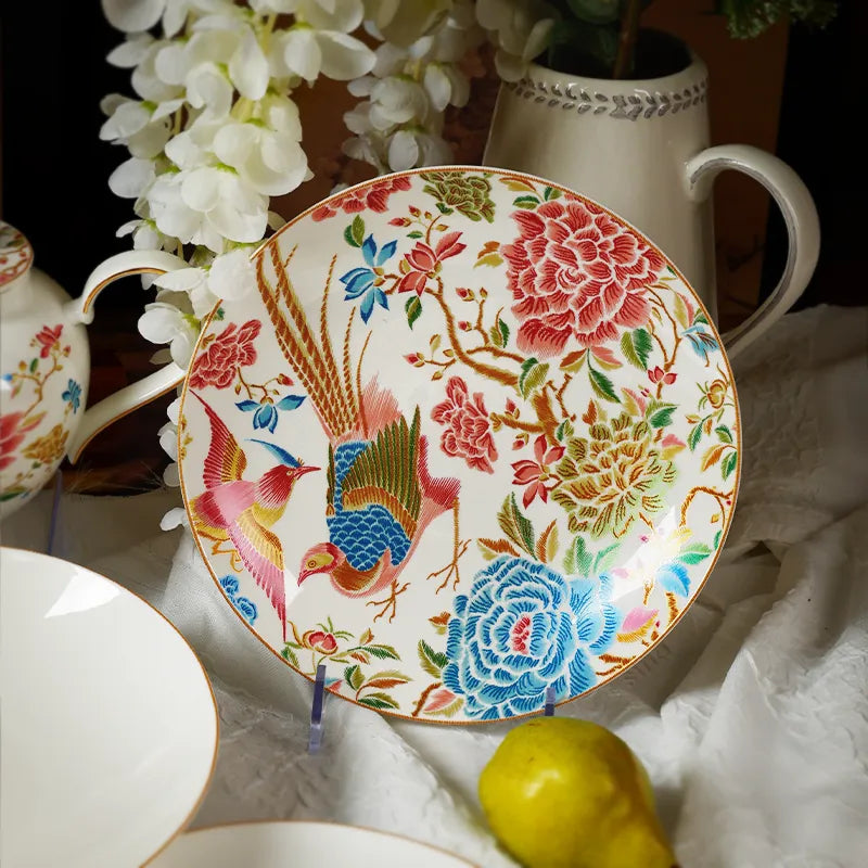 Angled 9’’ round bone china salad plate on stand with white floral decor and a pear.