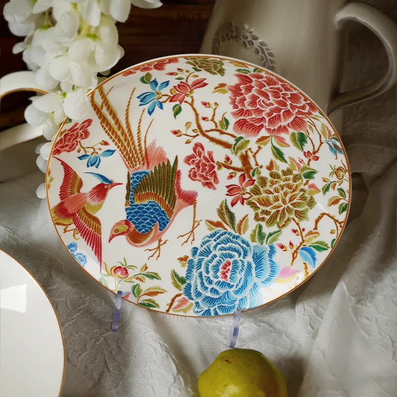 Flat-laid 9’’ round bone china salad plate with white floral decor and a pear.