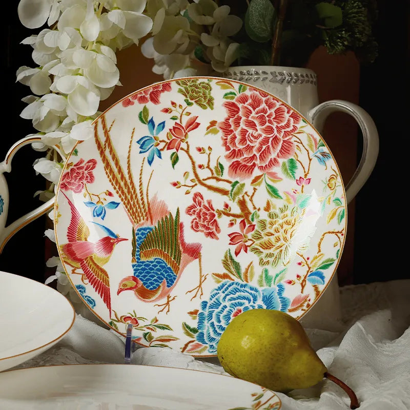 Two 9’’ round bone china salad plates upright with white floral decor and a pear.
