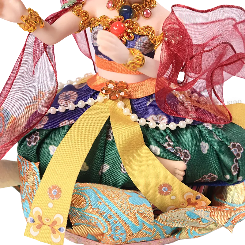 Skirt detail of 9-inch Dunhuang "Harp Melody" doll with intricate blue/gold embroidery.