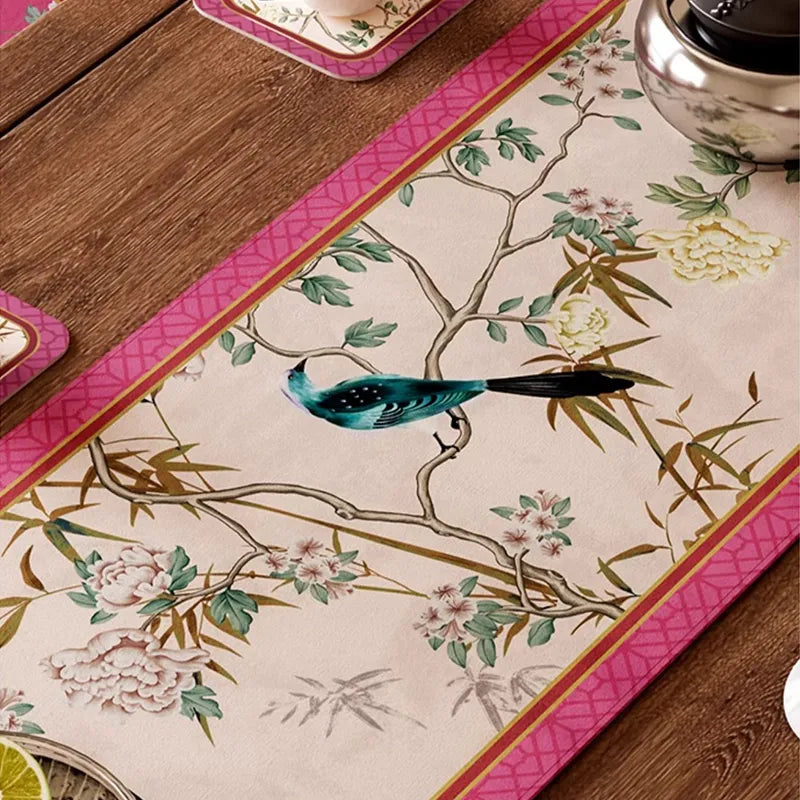 Artisan-detailed Chinoiserie birds and earthy-toned florals on soft pink runner.