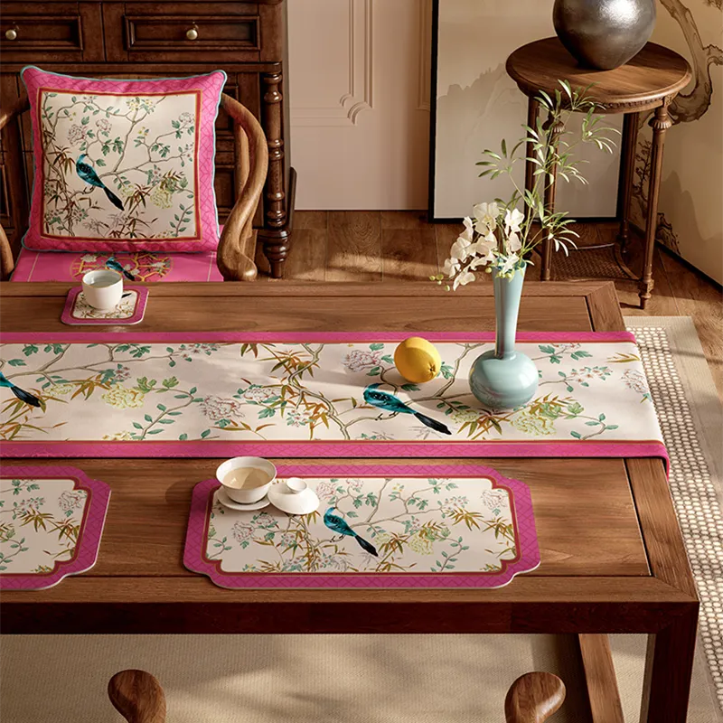 Luxe pink table runner with coordinating coasters, lemons, and floral arrangement for cohesive tablescaping.