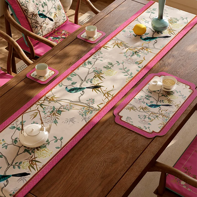 Angled view of floral bird table runner with lemons and vase, highlighting color-matched coasters.