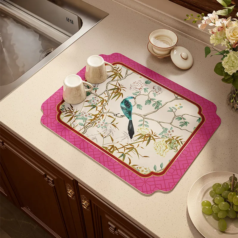 Bird-and-floral kitchen mat organizing cups on countertop, designed for spill absorption.