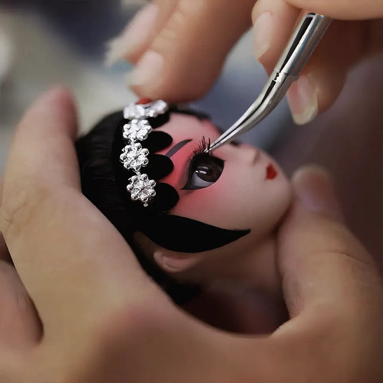 In this intimate dance of tradition and precision, skilled hands delicately apply crimson waves to porcelain-like cheeks—each brushstroke echoing centuries of Peking Opera artistry.