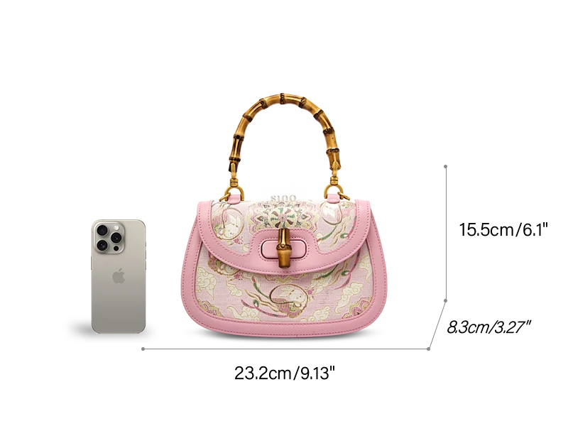Detailed dimensions of a luxury pink Song Dynasty brocade handbag crafted from mulberry silk, featuring a bamboo handle and intricate floral motifs. Measurements include length (9.13in/23.2cm), height (6.1in/15.5cm), depth (3.27in/8.3cm), and adjustable strap drop (18in/45cm). Flat lay technical diagram on clean white background. Perfect for buyers prioritizing craftsmanship and cultural heritage in sustainable fashion accessories.