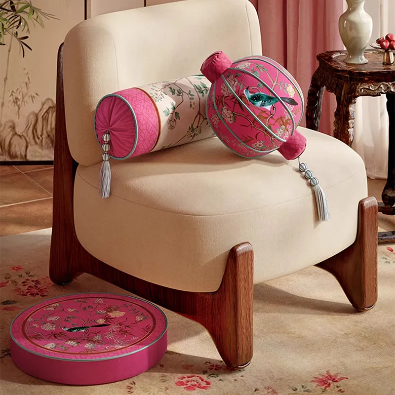 Armrest and lantern chinoiserie window lattice pillows on chair.