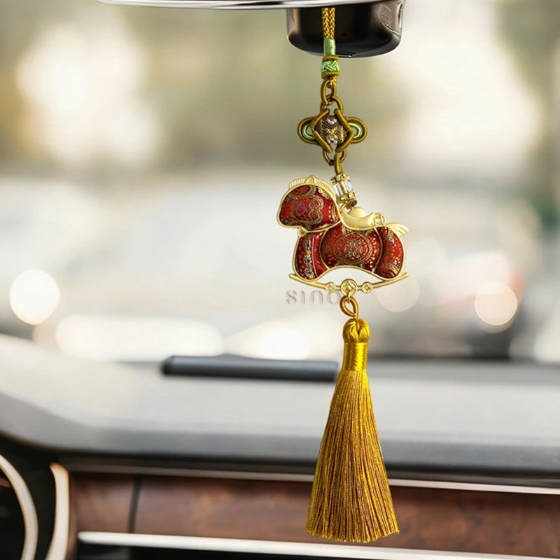 Auspicious Song brocade Red Ruyi horse tassel charm hanging inside a car with a red horse design and long golden tassel.