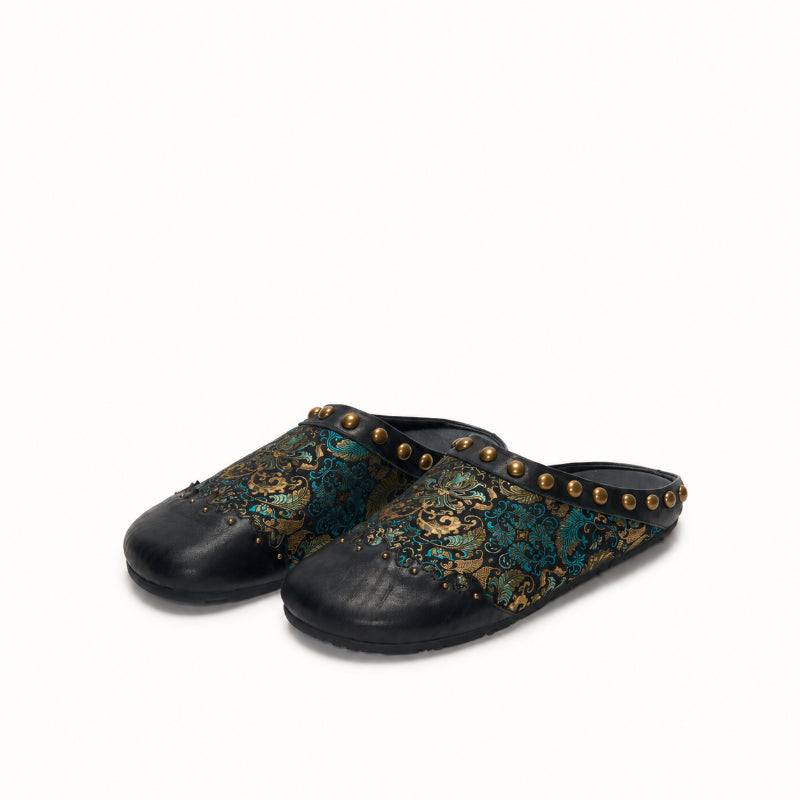 Black Ancient Leaf Song Brocade mules for women with handcrafted textile details.