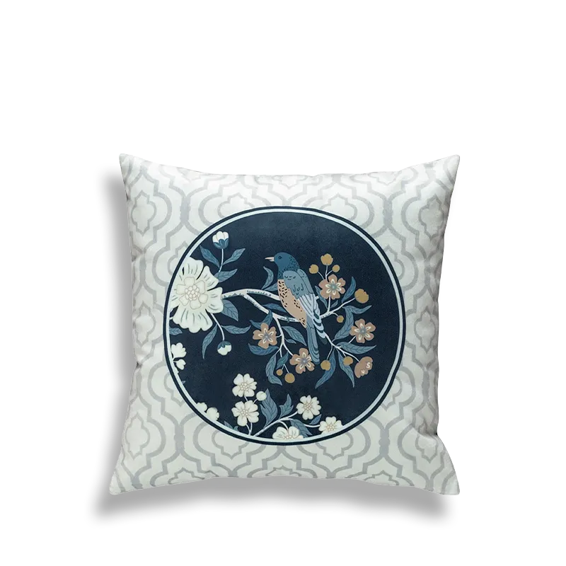 Blue embroidered pillow with circular birds and flowers.