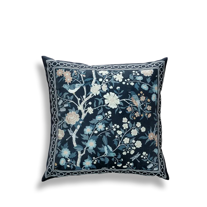 Blue embroidered pillow featuring full floral and bird scene.