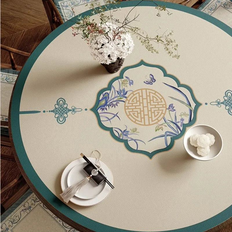 Blue round leather table mat with Chinoiserie center pattern.