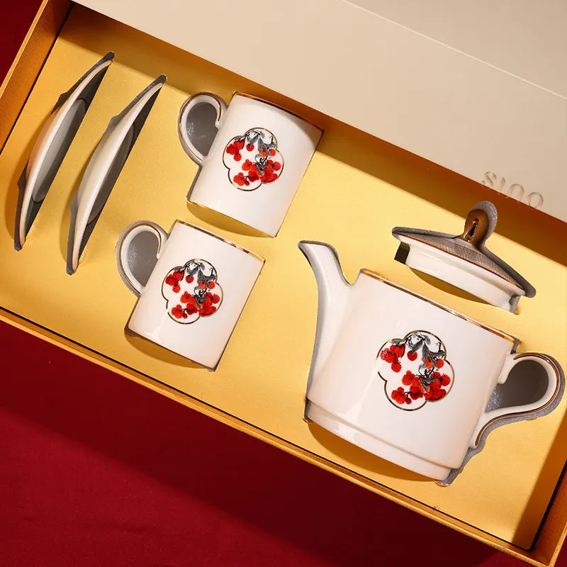 Bone china tea set inside gift box with teapot, two tea cups, and saucers in bird and red berry motif.