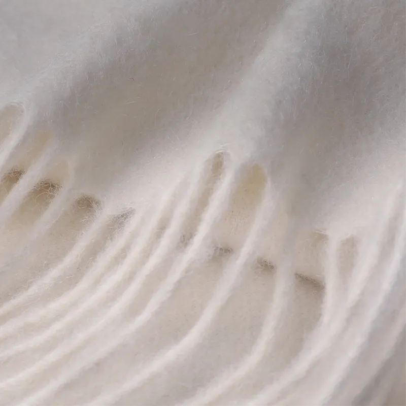 Delicate hand-knotted fringe on cashmere scarf.