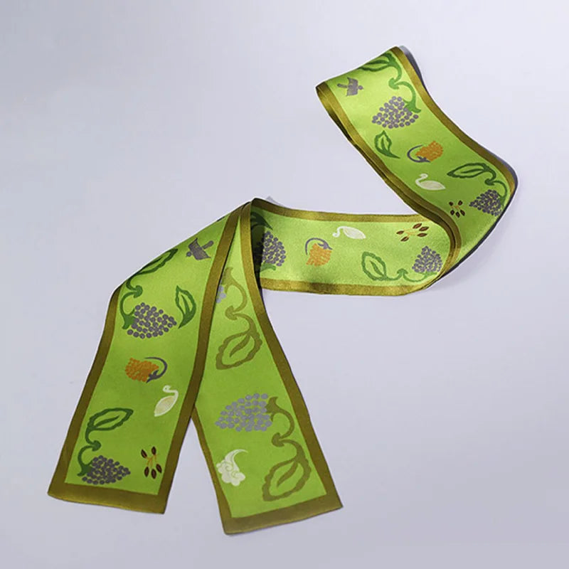 Flat lay of the Chinese Grape Vine Print Mulberry Silk Twilly featuring grape clusters, leaves, and delicate decorative motifs.