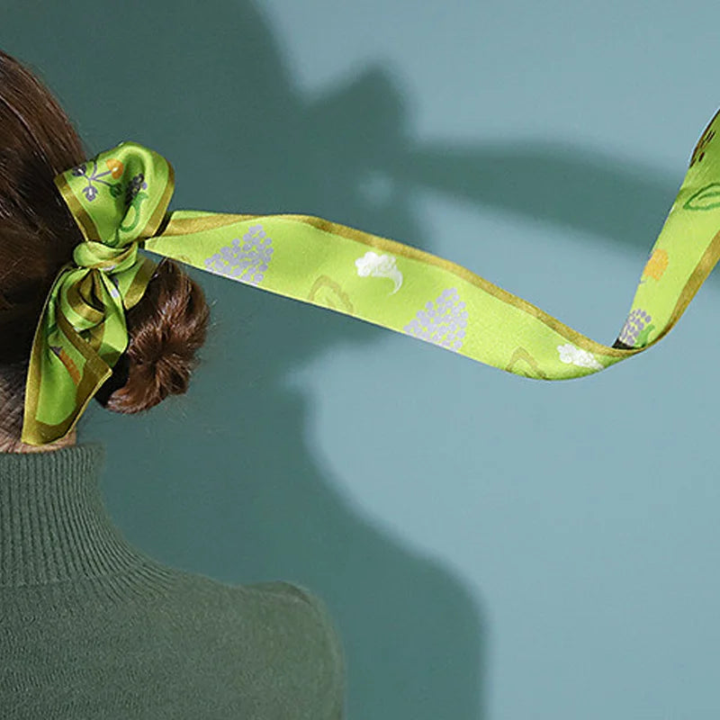 Chinese Grape Vine Print Mulberry Silk Twilly styled as a hair bow around a bun, showcasing its flowing silhouette.