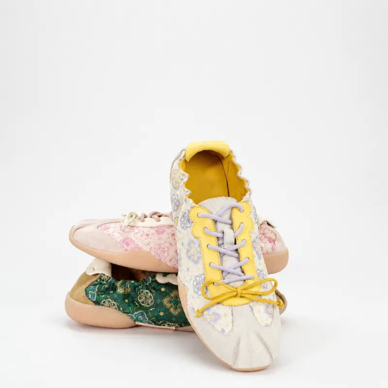 Chinese-inspired Shu Brocade sneakers displaying elegant woven patterns and ballet-inspired footwear design.