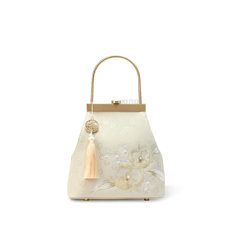 Luxury mulberry silk clutch with embroidered butterfly kiss-lock.