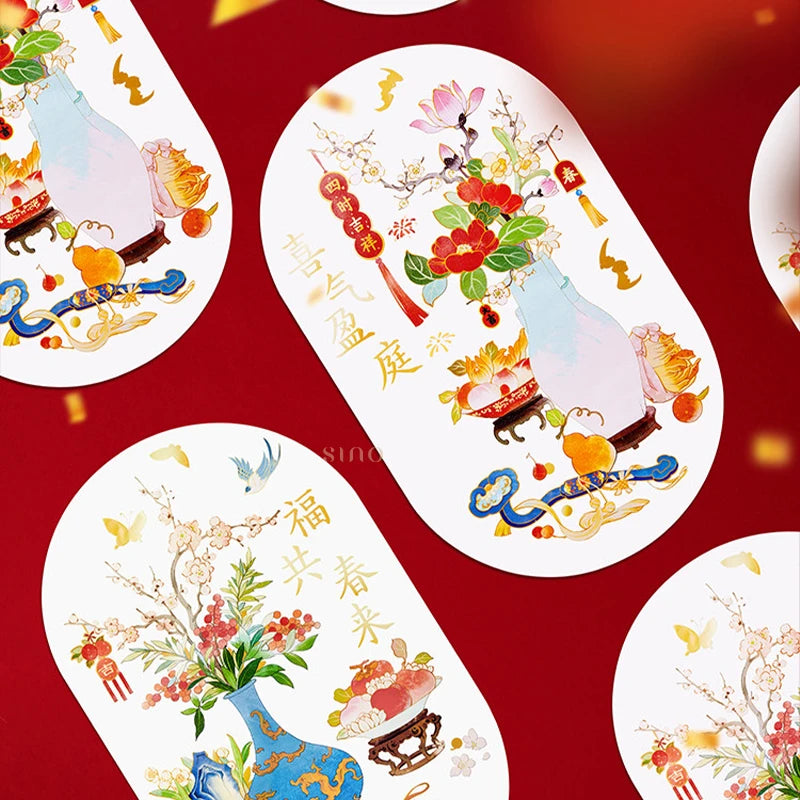 Decorative Chinese New Year window clings arranged on a red background, showcasing flowering branches, colorful porcelain vases, auspicious fruits, and traditional Chinese motifs.