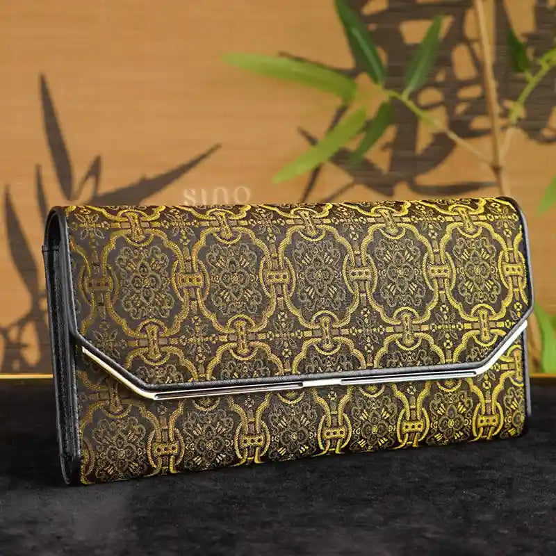 Chinese Song Brocade Dingsheng Motif Leather Long Wallet displayed in a traditional Chinoiserie setting, highlighting its black and gold design.