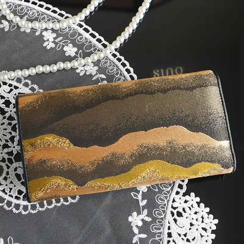 Chinese Song Brocade Flowing Clouds and Layered Peaks leather wallet displayed with lace and pearl accessories.
