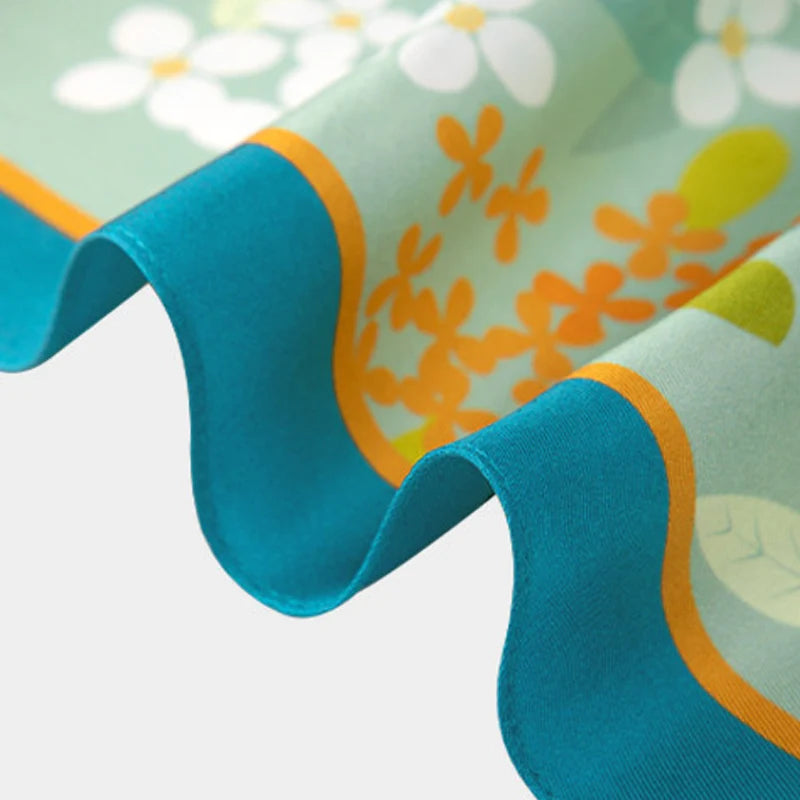 Close-up of the finely finished edge of the Chinese Verdant Garden Print Mulberry Silk Diamond Scarf showing refined craftsmanship.