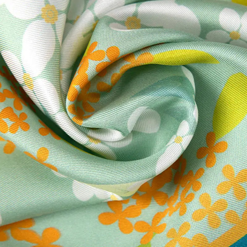 Close-up of the premium mulberry silk fabric of the Chinese Verdant Garden Print Diamond Scarf showing its smooth texture and soft sheen.