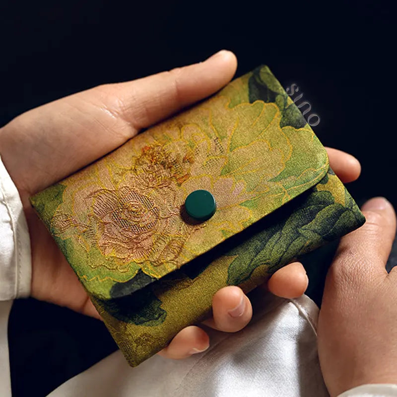 Handheld view of the Chinese Xiangyunsha Silk Floral Snap Card Holder Wallet showing its compact size and traditional floral textile design.