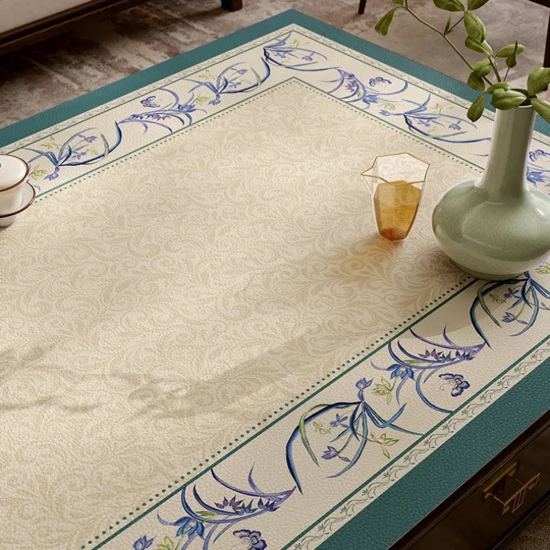 Chinoiserie blue leather coffee table mat with floral pattern detail.