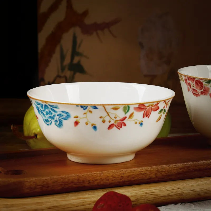 Chinoiserie bone china round bowl on wooden shelf (front view).