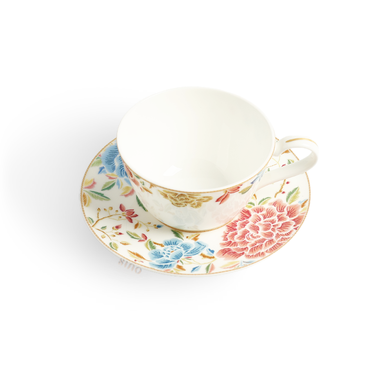 Overhead view of floral tea cup on matching saucer.
