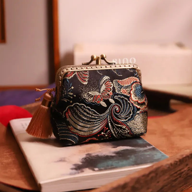 Lifestyle display of the Chinoiserie Hand-Finished Silk Mini Coin Purse Wallet - Black Butterfly, a hand-finished silk kiss lock coin purse with butterfly motif styled in an elegant Chinese-inspired setting.