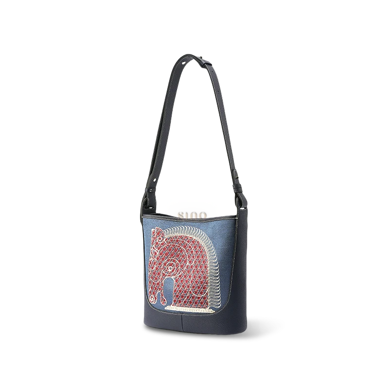 Side profile showing bag depth and adjustable leather strap.