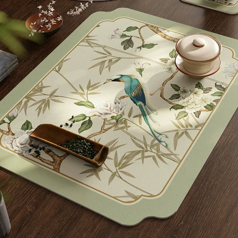 Top view of Style A draining mat in jade green leather placemat with teacup on tea table.