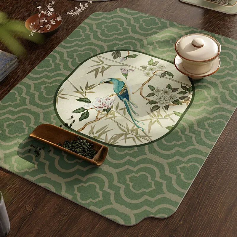 Top view of Style B draining mat in jade green leather placemat with teacup on tea table.