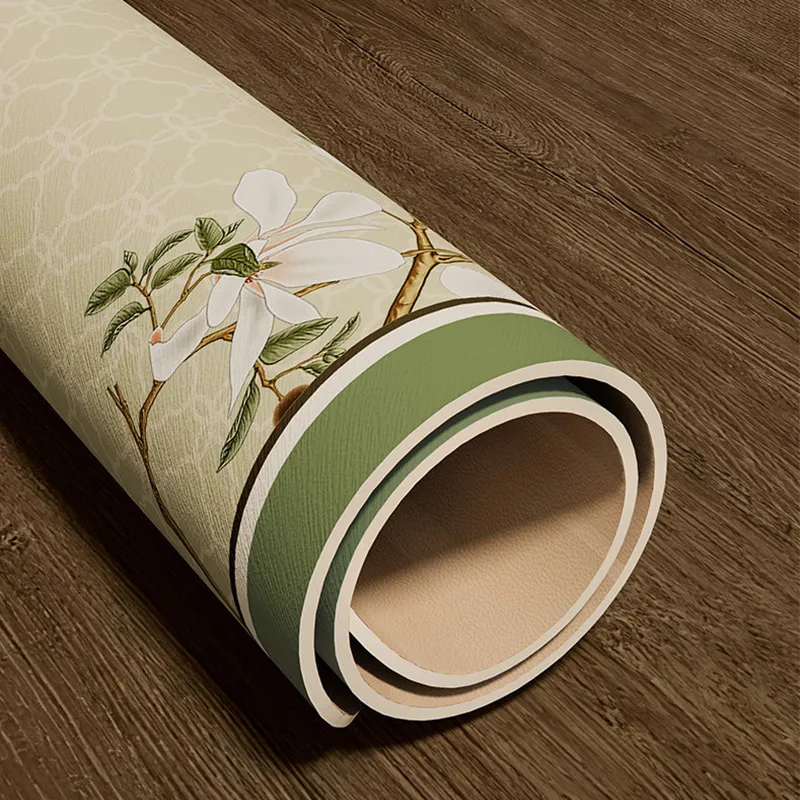 Roll-up storage of jade green leather placemat showing crease-resistant finish.